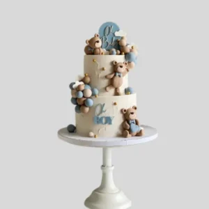Two-tier white cake decorated with three cute bears chilling and playing, designed in a fun and playful theme.